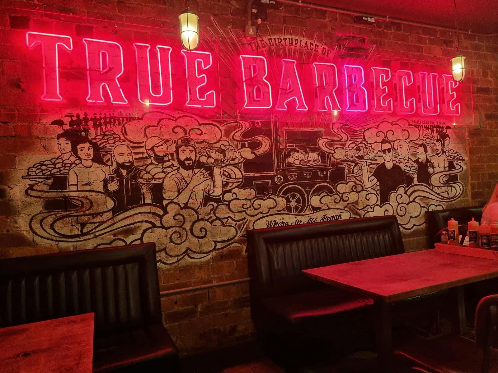 Vibrant barbecue restaurant with neon sign, perfect for casual gatherings and events.