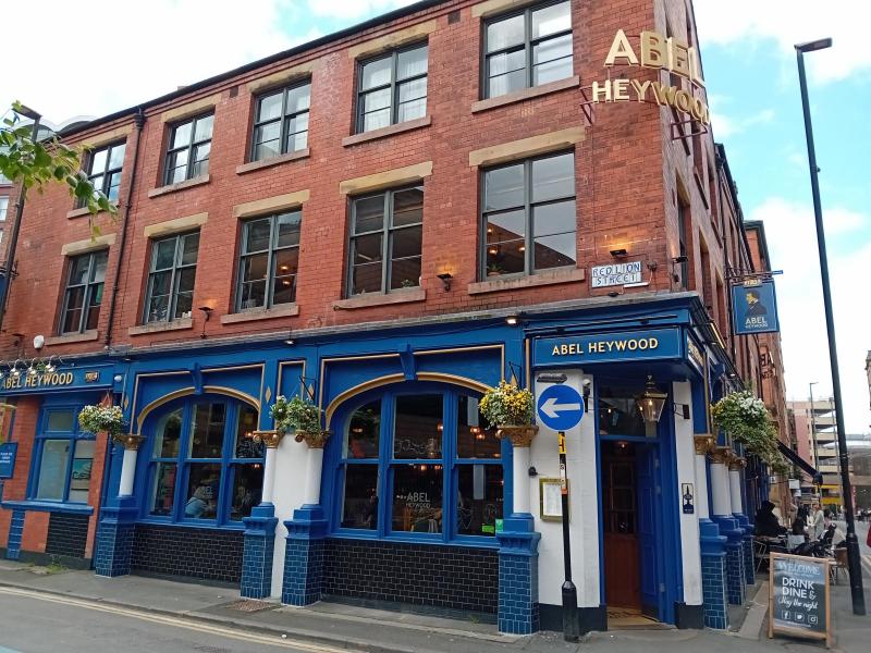 Abel Heywood bar with brick exterior, ideal for casual networking events and gatherings.