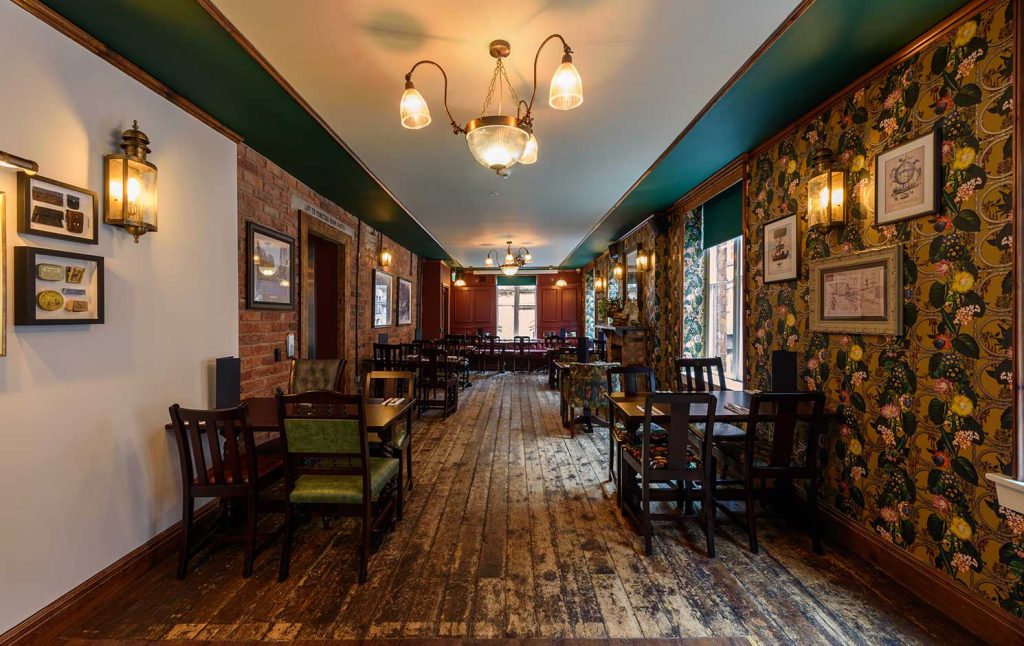 Charming event space in Abel Heywood with rustic floor and floral decor for gatherings.