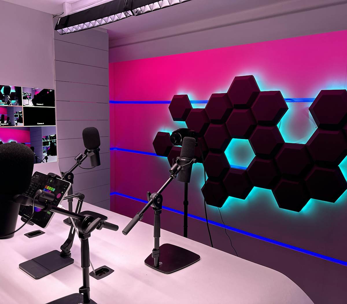 Modern podcasting setup in Rehearsal Studio, vibrant lighting for events and content creation.