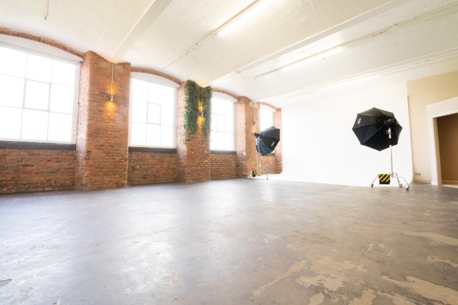 Spacious Honey Street Studio with large windows and exposed brick for versatile events.
