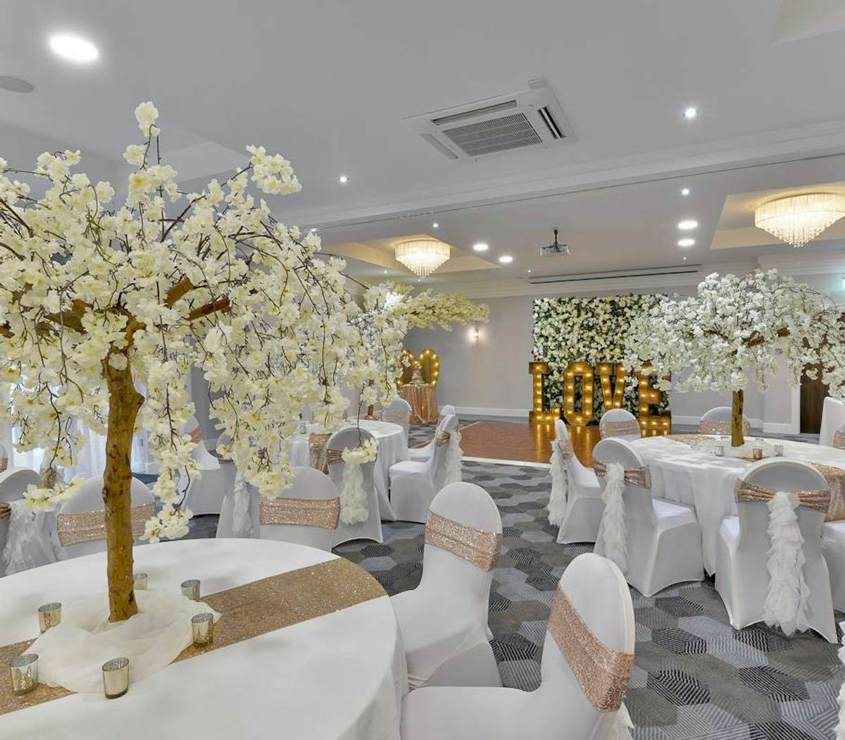 Elegant Hopwood Suite with cherry blossom trees, ideal for weddings and upscale events.