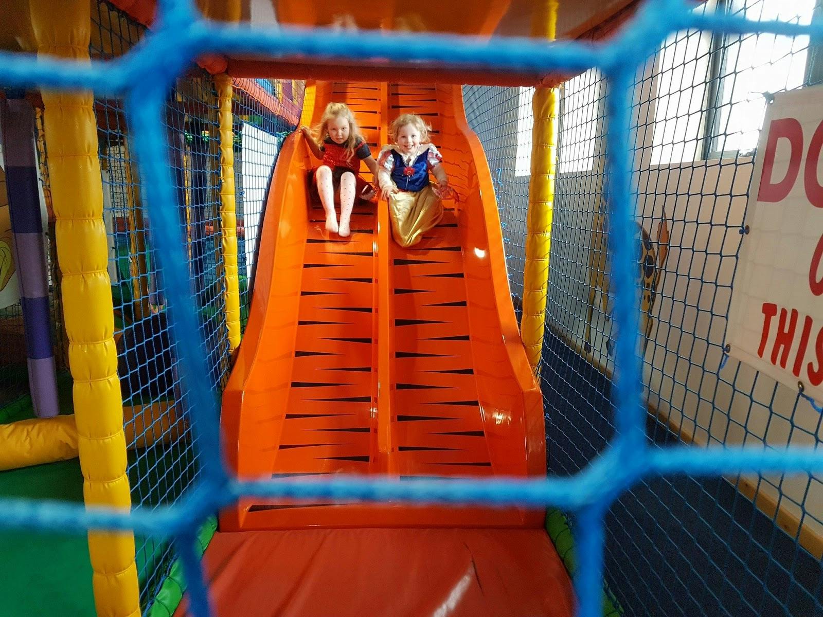 Indoor play area with orange slides, perfect for kid-friendly events and birthday parties.