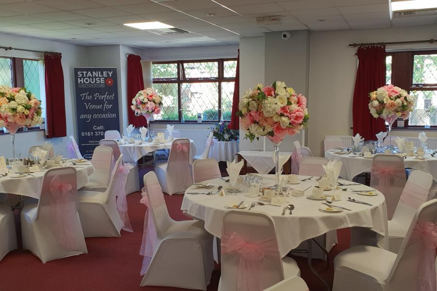 Elegant banquet hall with white linens for weddings and formal events.