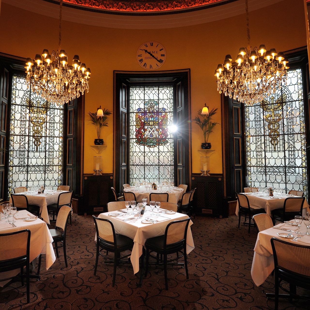Elegant fine dining restaurant in The Dome Edinburgh with ornate chandeliers for upscale events.