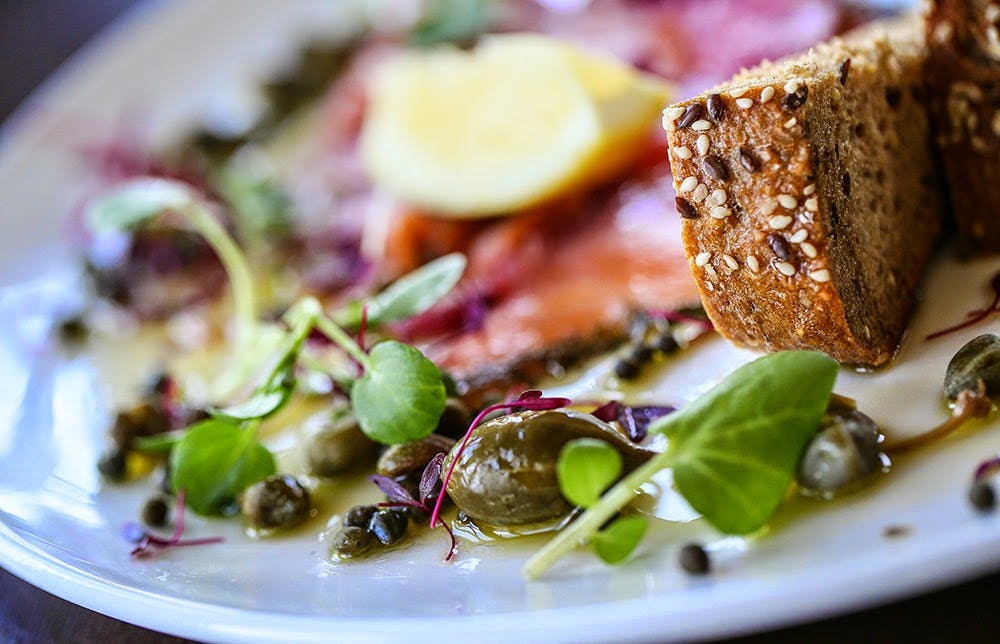 Elegant salmon dish with lemon and capers at Farestone Room, catering for events.