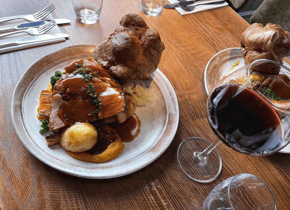 Gourmet meal with tender meat and wine glass in upscale restaurant setting for events