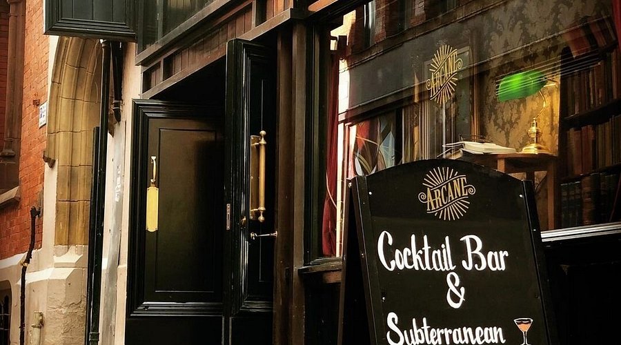 Inviting entrance of Arcane Cocktail Bar, perfect for exclusive events and gatherings.