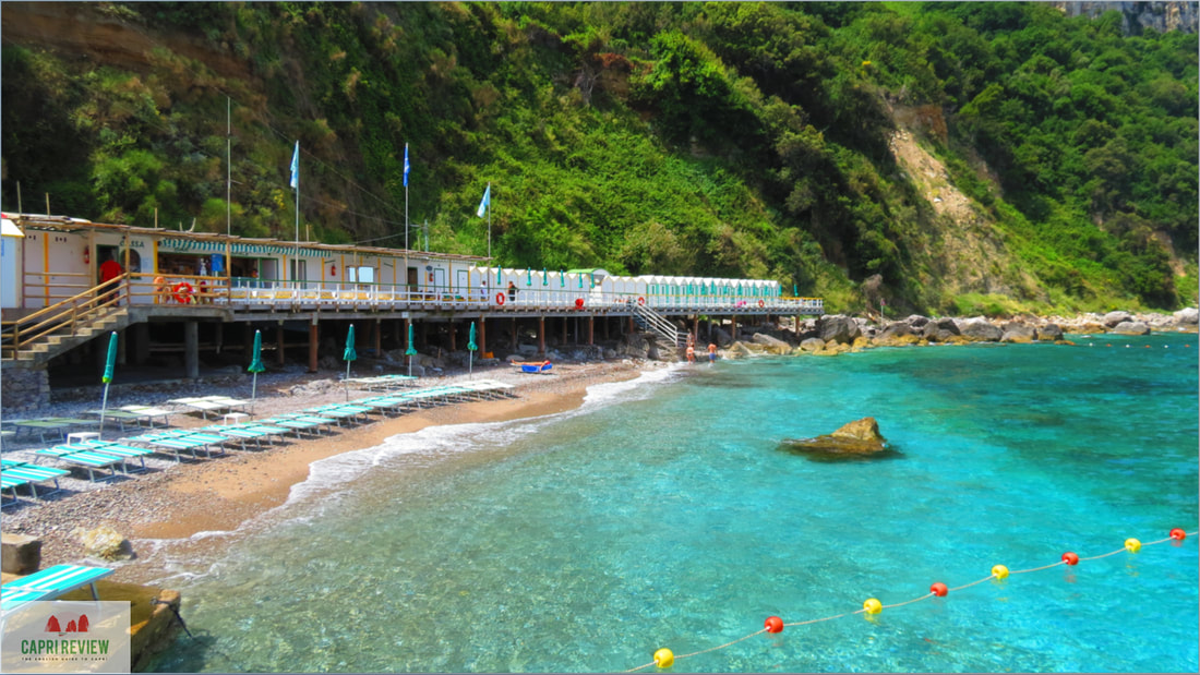 Bagni Tiberio beach club in Capri with a wooden deck, perfect for corporate retreats.