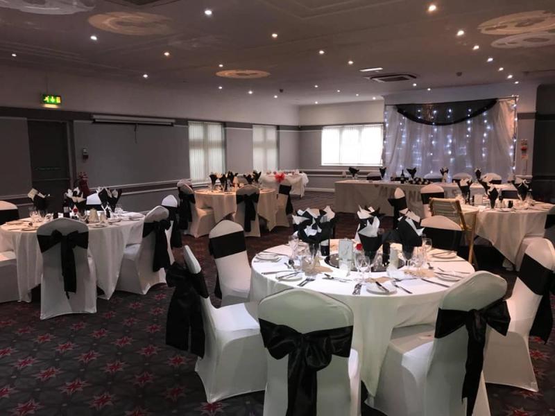 Elegant banquet room with round tables for weddings and corporate events at St John's Parish Centre.