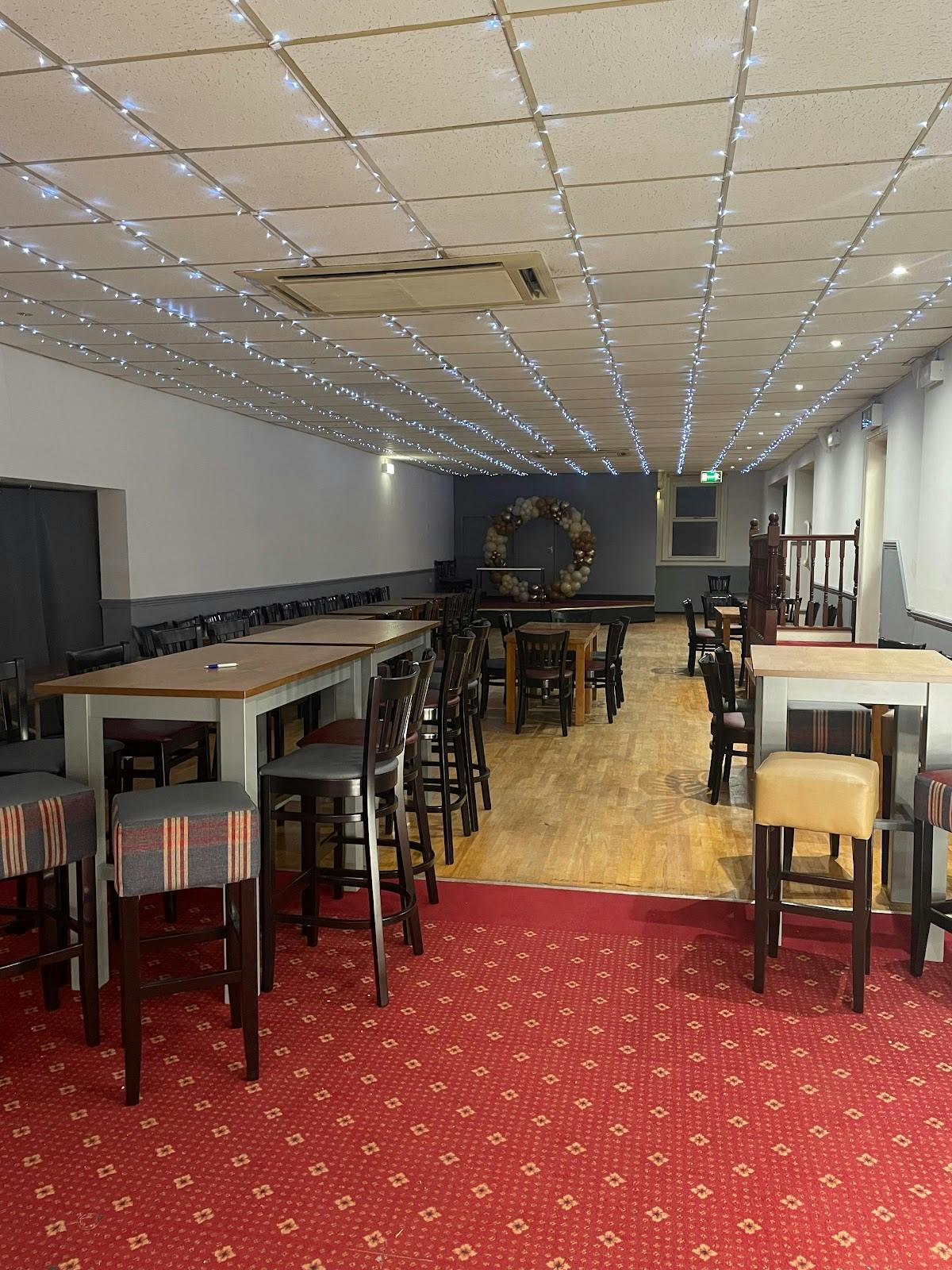 Modern event space with high-top tables in St John's Parish Centre for gatherings.