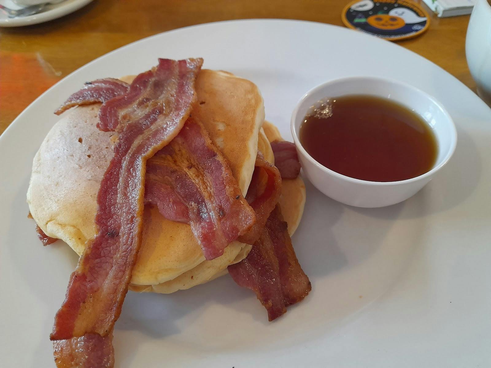 Breakfast pancakes with bacon at Bus Stop Cafe for meetings and events.