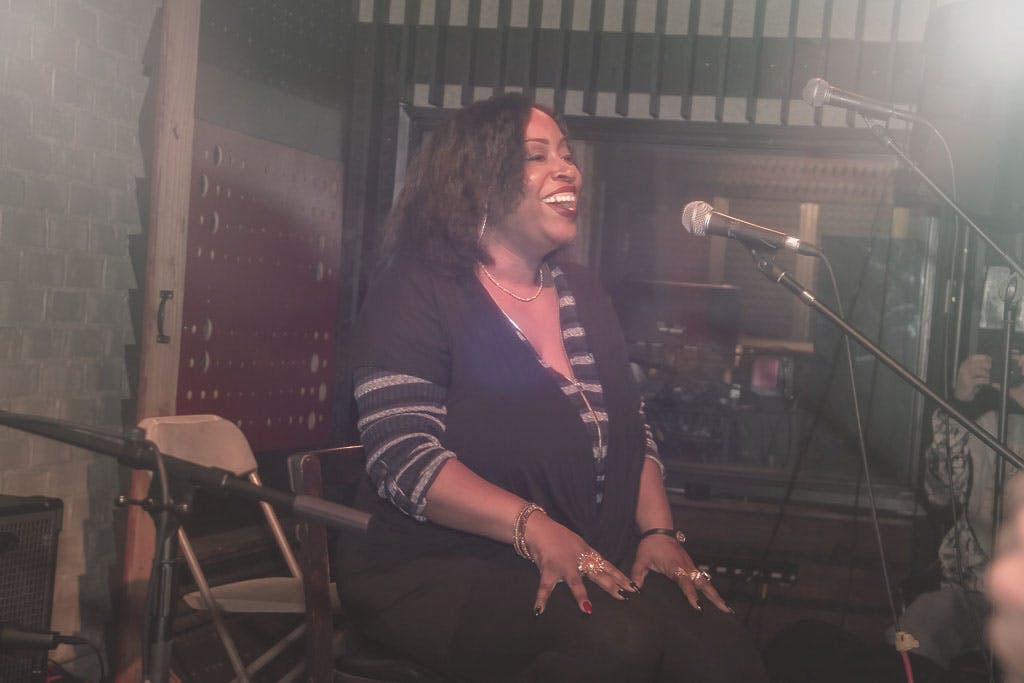 Engaging speaker in warm, relaxed studio setting for networking events and workshops.