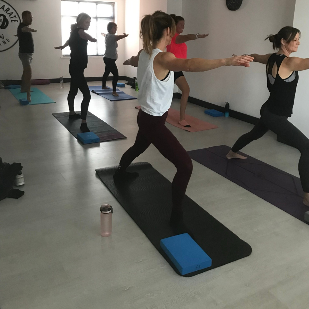 Group yoga class in serene studio for wellness retreats and team-building events.
