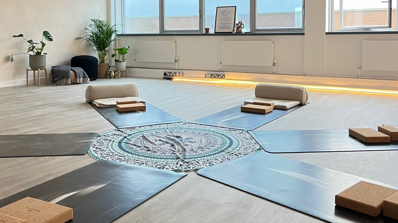 Tranquil yoga space with natural light for wellness events and meditation workshops.
