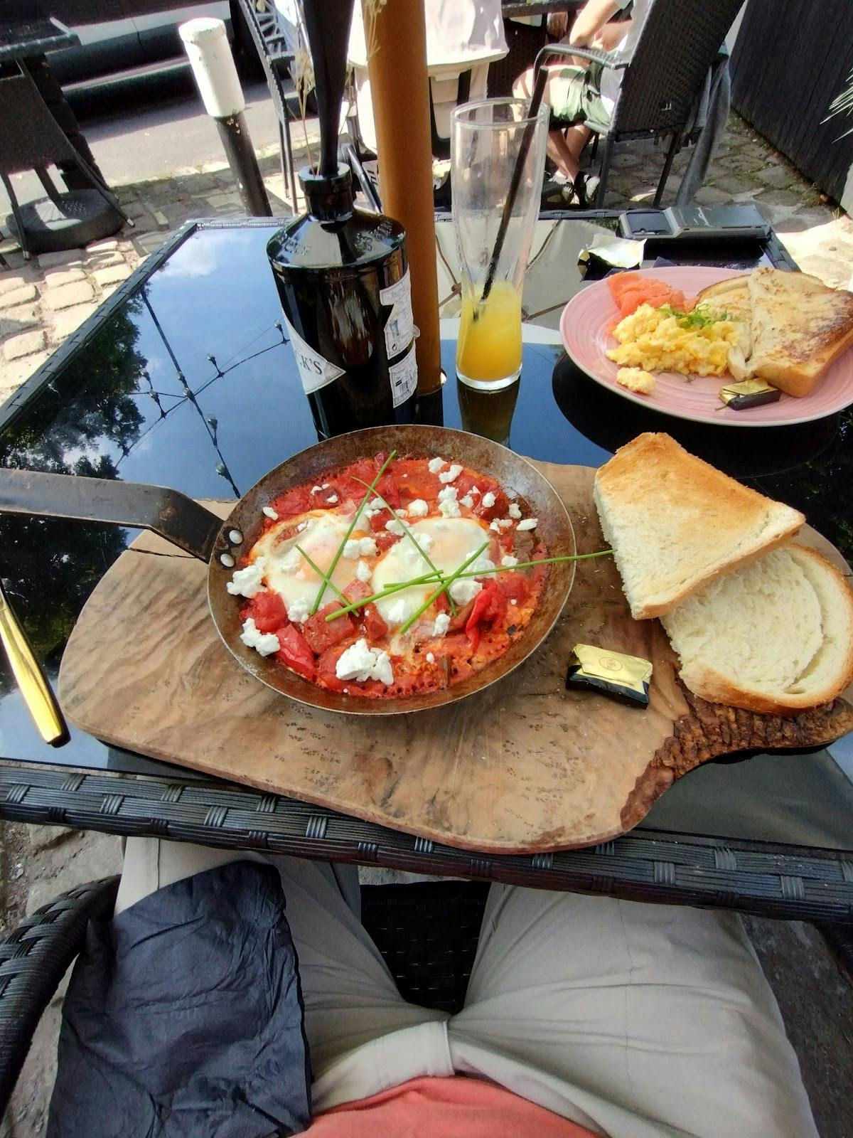 Vibrant breakfast dish with eggs in tomato sauce at The Delph Restaurant & Bar brunch.