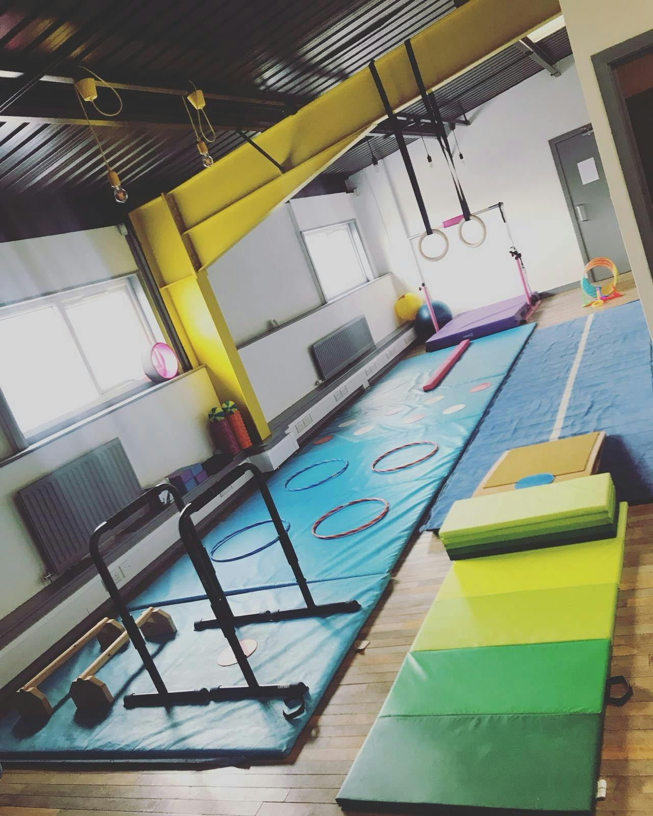 Pole dancing workshop in colorful, inviting activity space for wellness and team-building.