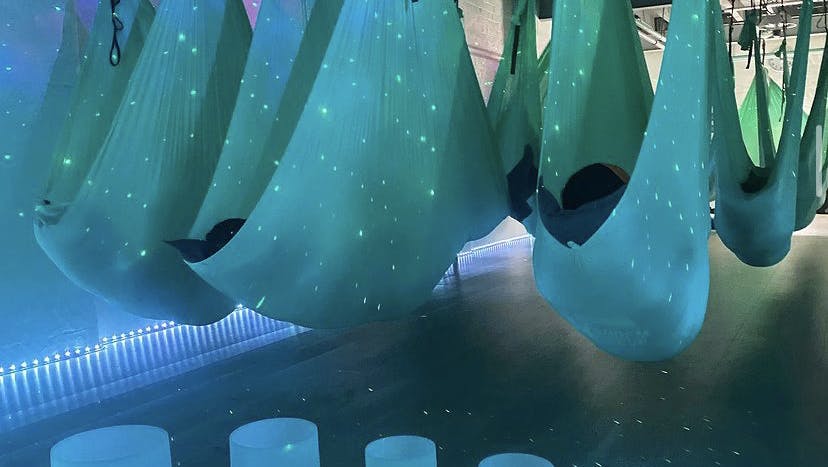 Pilates studio with suspended hammocks for creative wellness events and brainstorming.