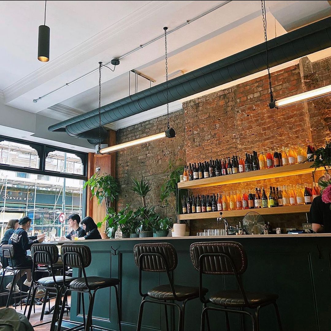 Vibrant brunch restaurant with stylish bar, ideal for networking and casual meetings.