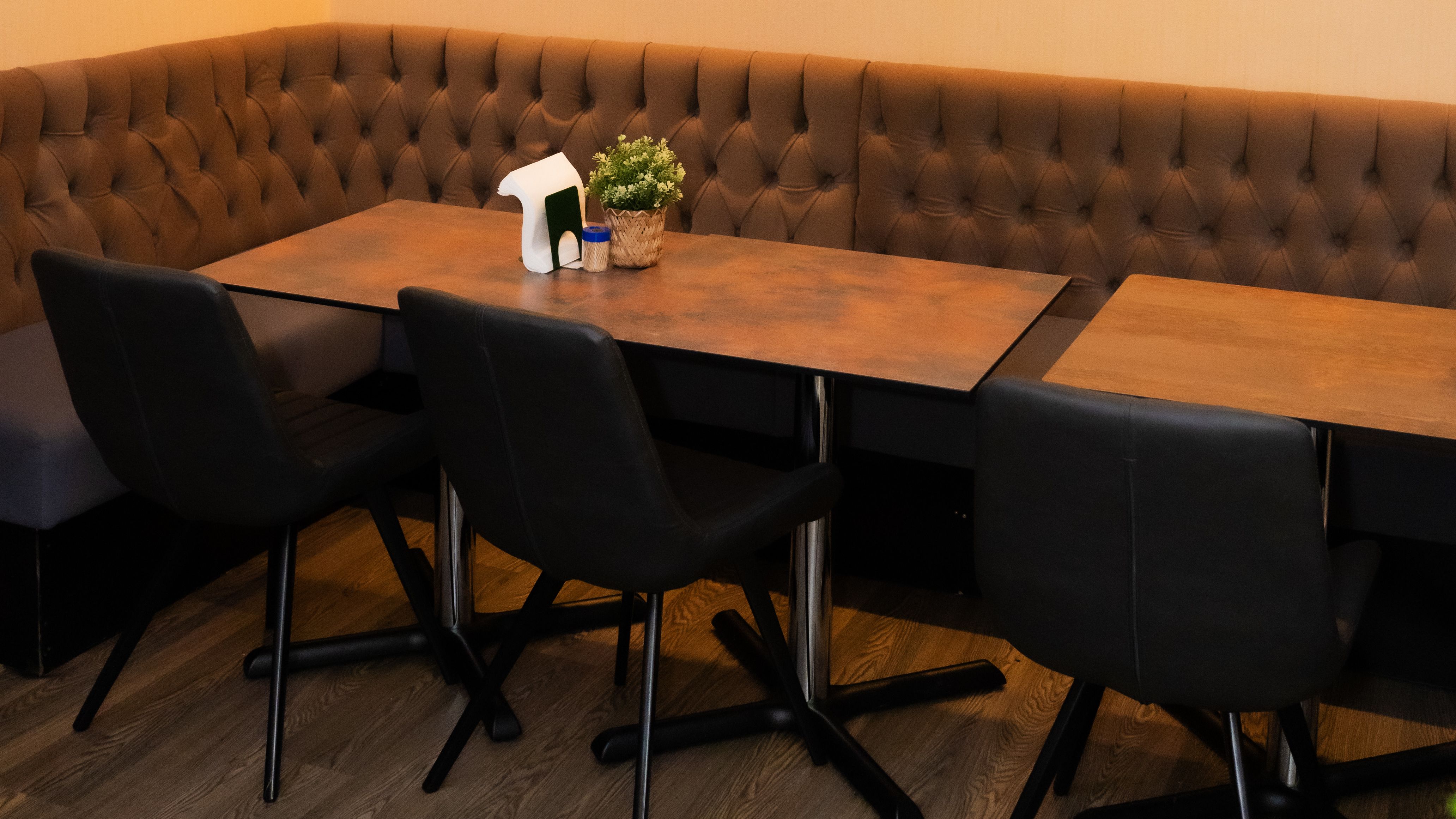 Modern meeting space with booth seating and greenery at Buka Royale for collaborative events.