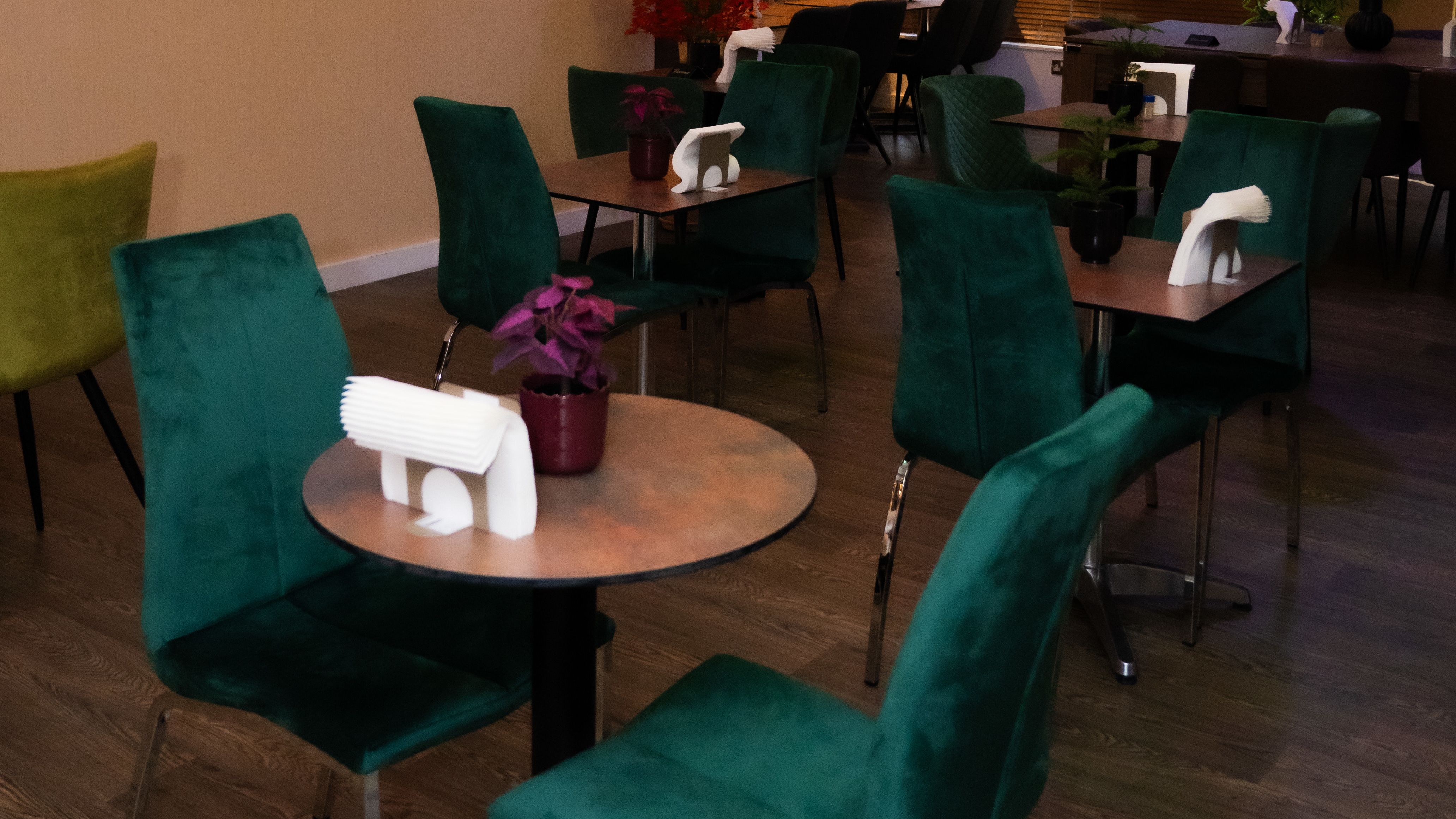 Chic Buka Royale bar with green chairs for intimate networking and brainstorming events.