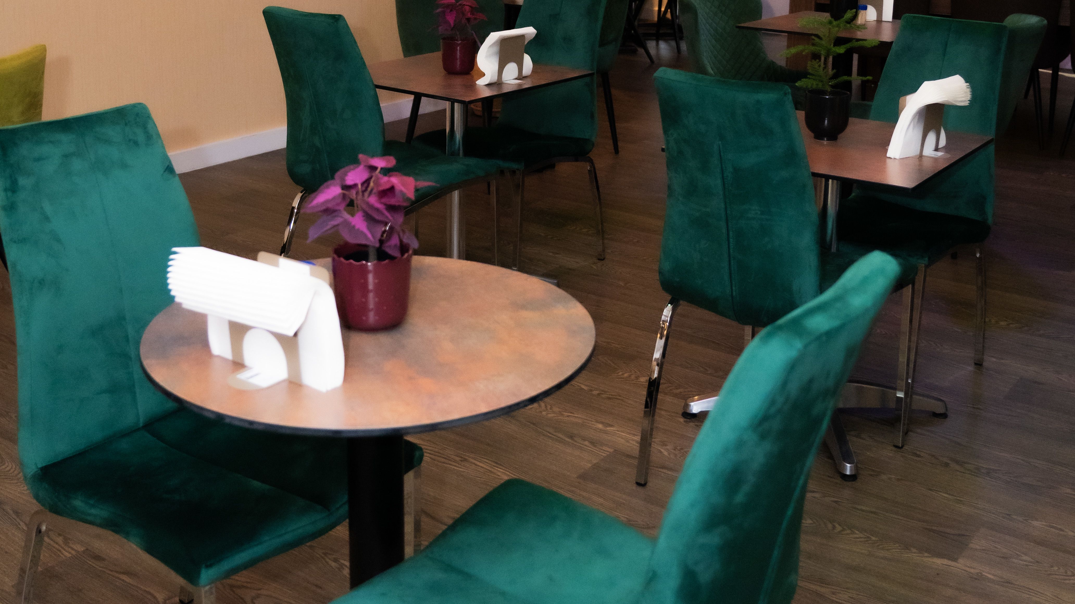 Cozy Buka Royale lounge with green velvet chairs for intimate meetings and events.