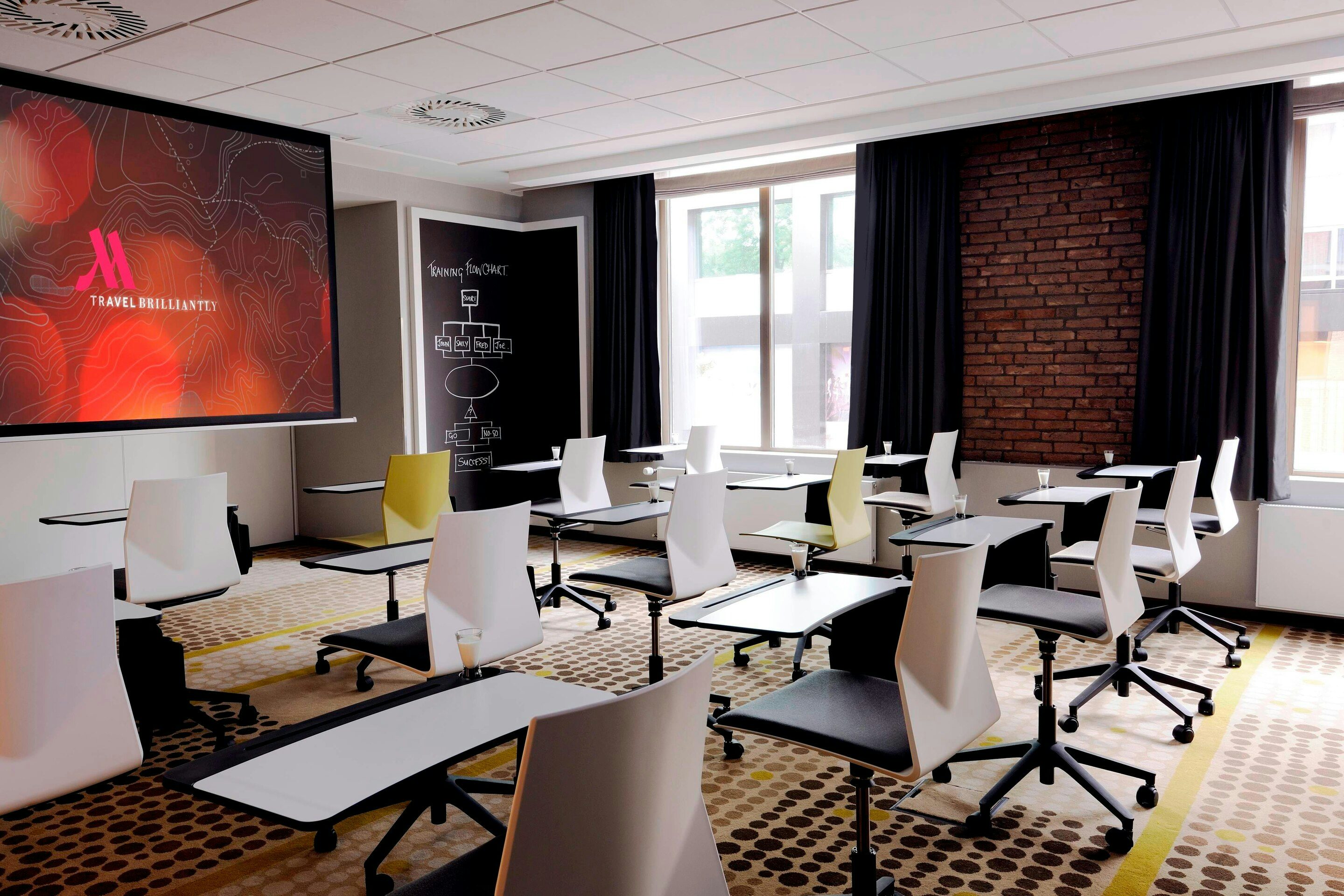 Modern meeting room with large windows in Amsterdam Marriott for corporate events.