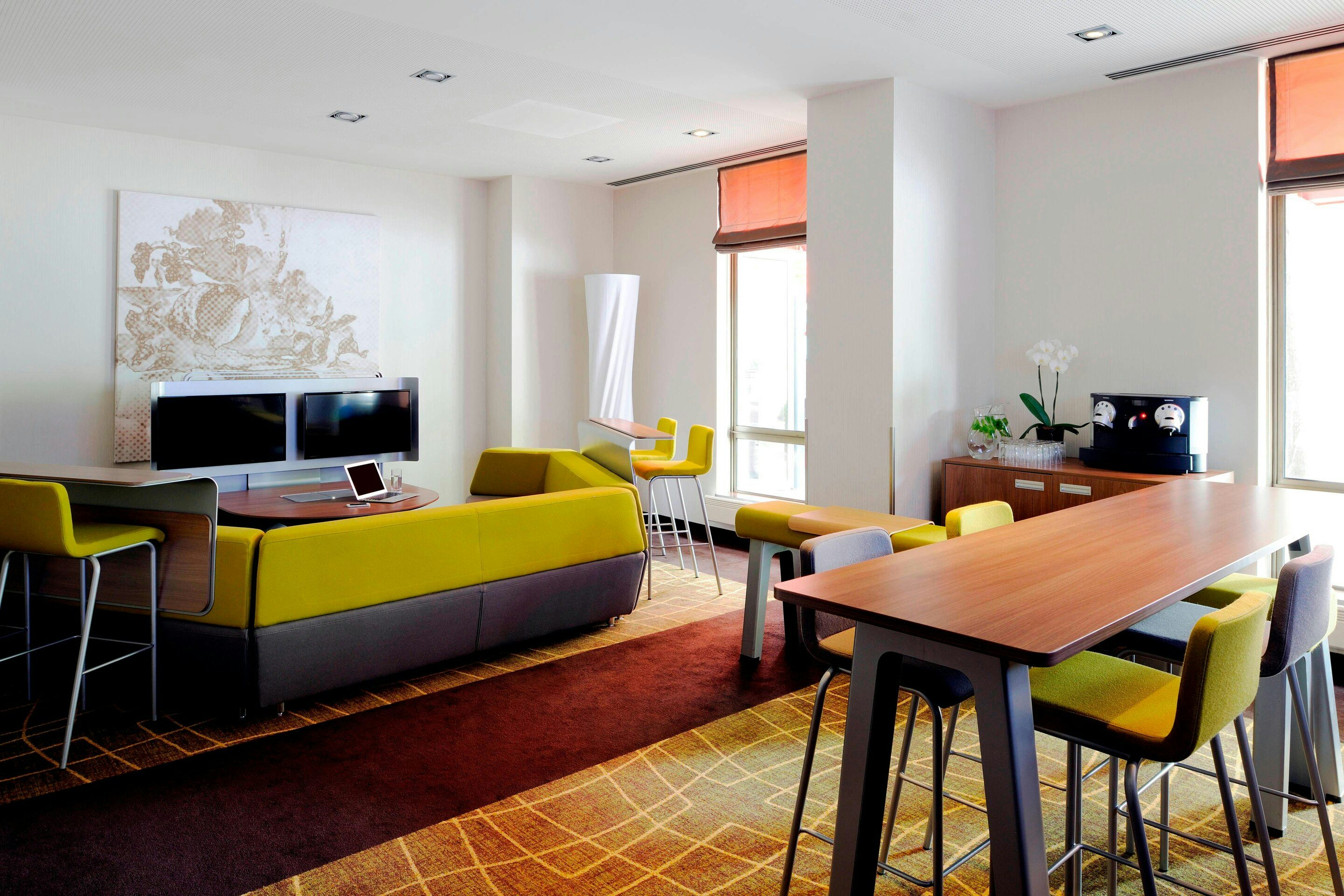 Modern meeting space in Amsterdam Marriott, featuring vibrant decor for collaborations.