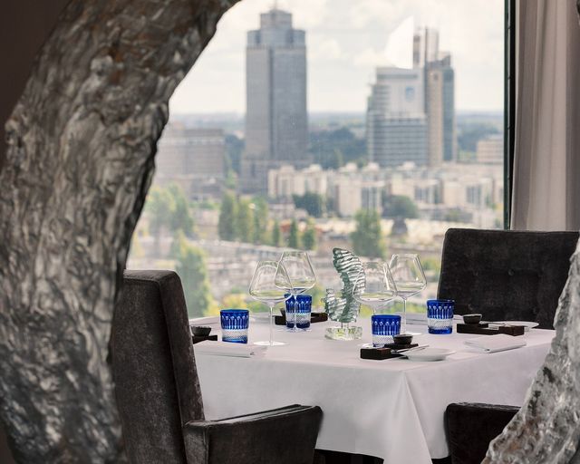 Lounge at Hotel Okura Amsterdam with skyline view, perfect for corporate events and gatherings.