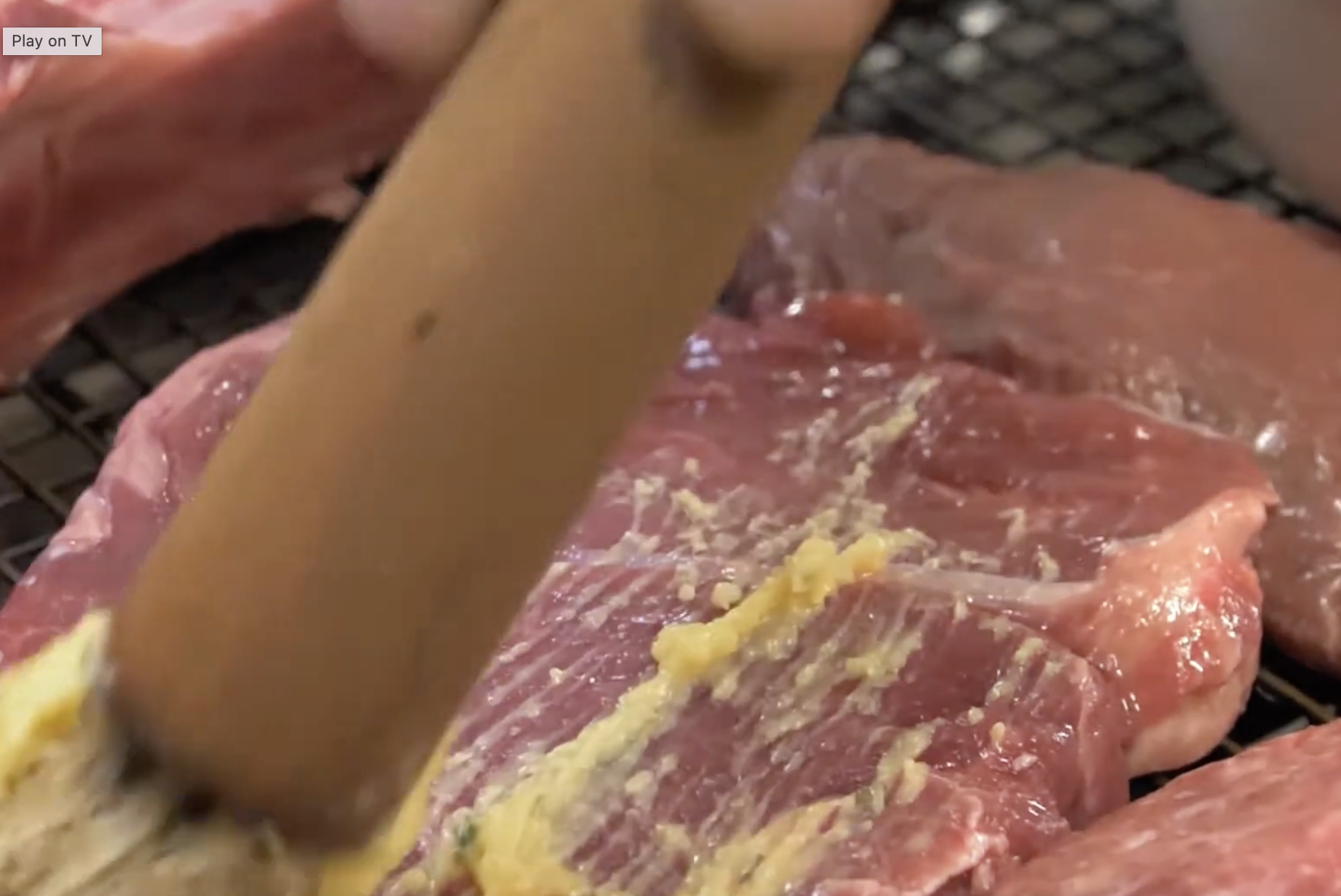 Close-up of marinated meat for grilling at Smokin' Grill Steakhouse event catering.