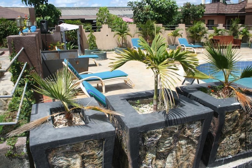 Outdoor restaurant event space with pool, loungers, and lush greenery at Galaxy Resort Kitengela.