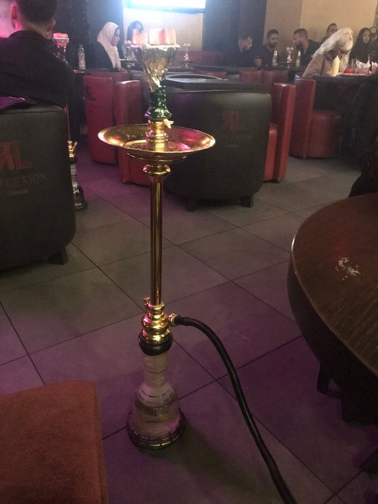 Modern lounge bar with stylish seating and hookah, perfect for social events and gatherings.