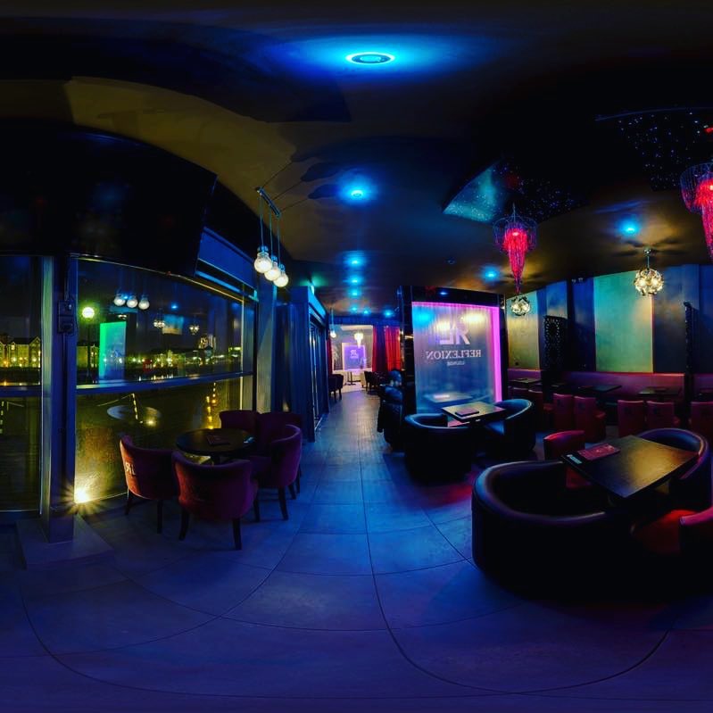 VIP event in Reflexion Lounge with modern decor and vibrant lighting for networking.