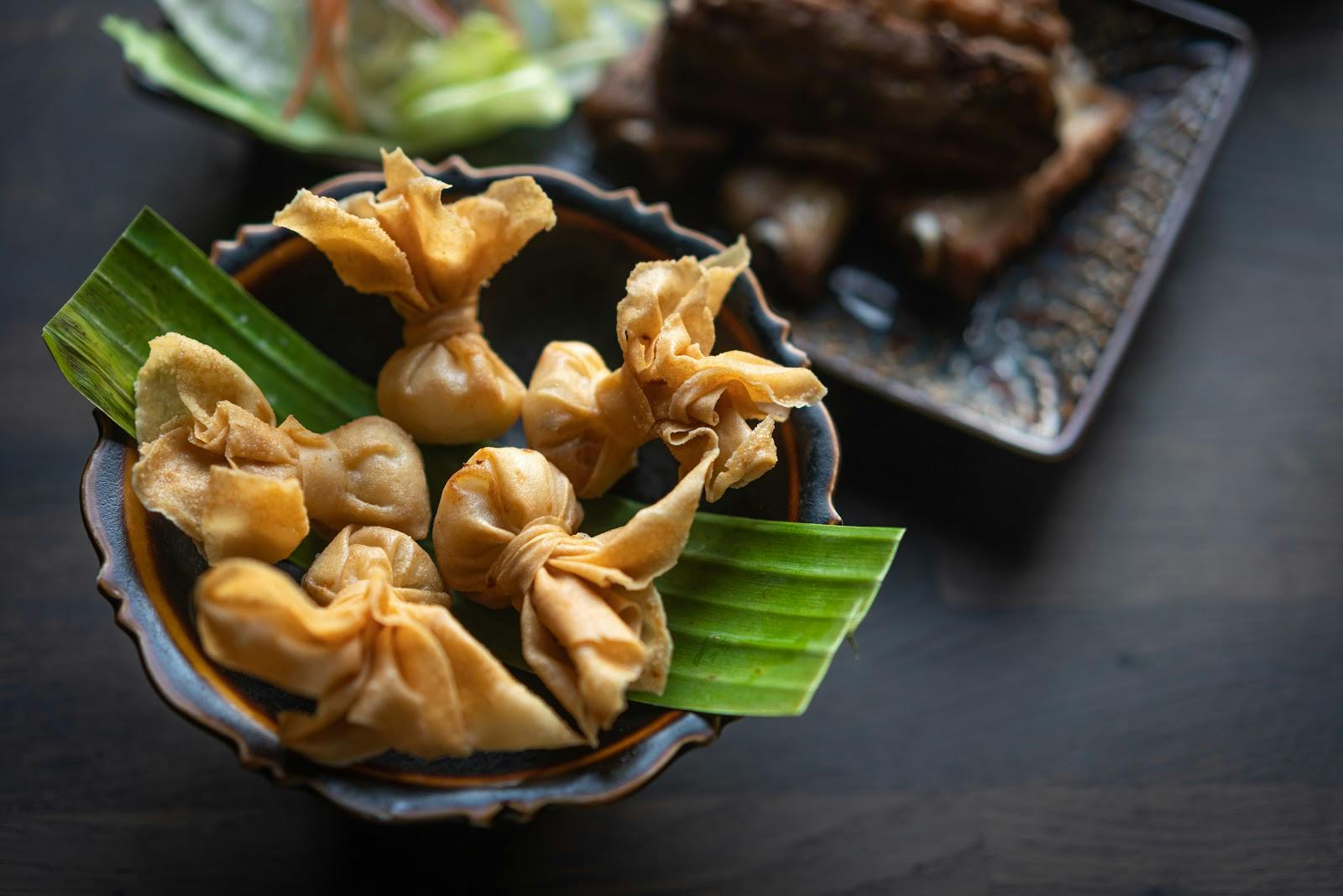 Gourmet dumplings in banana leaves at Mai Thai Deli, ideal for upscale events.