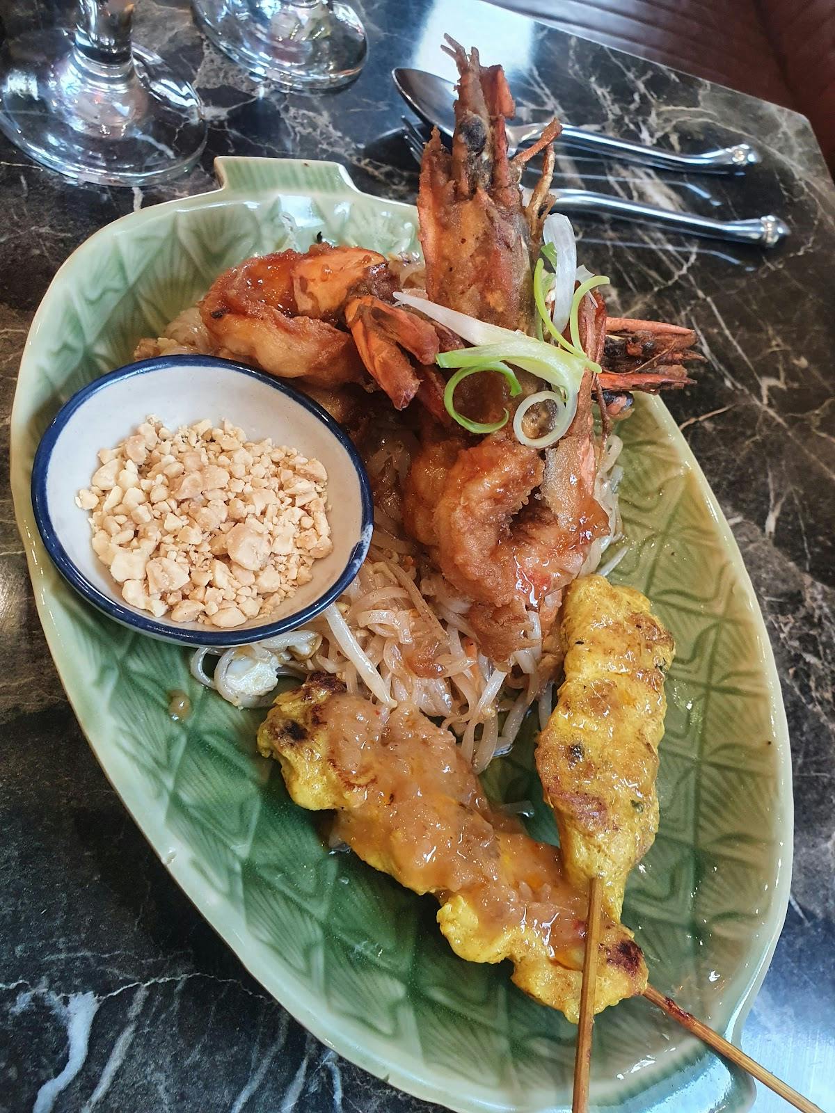 Vibrant shrimp noodles plate at Mai Thai Deli for networking events and Asian cuisine.