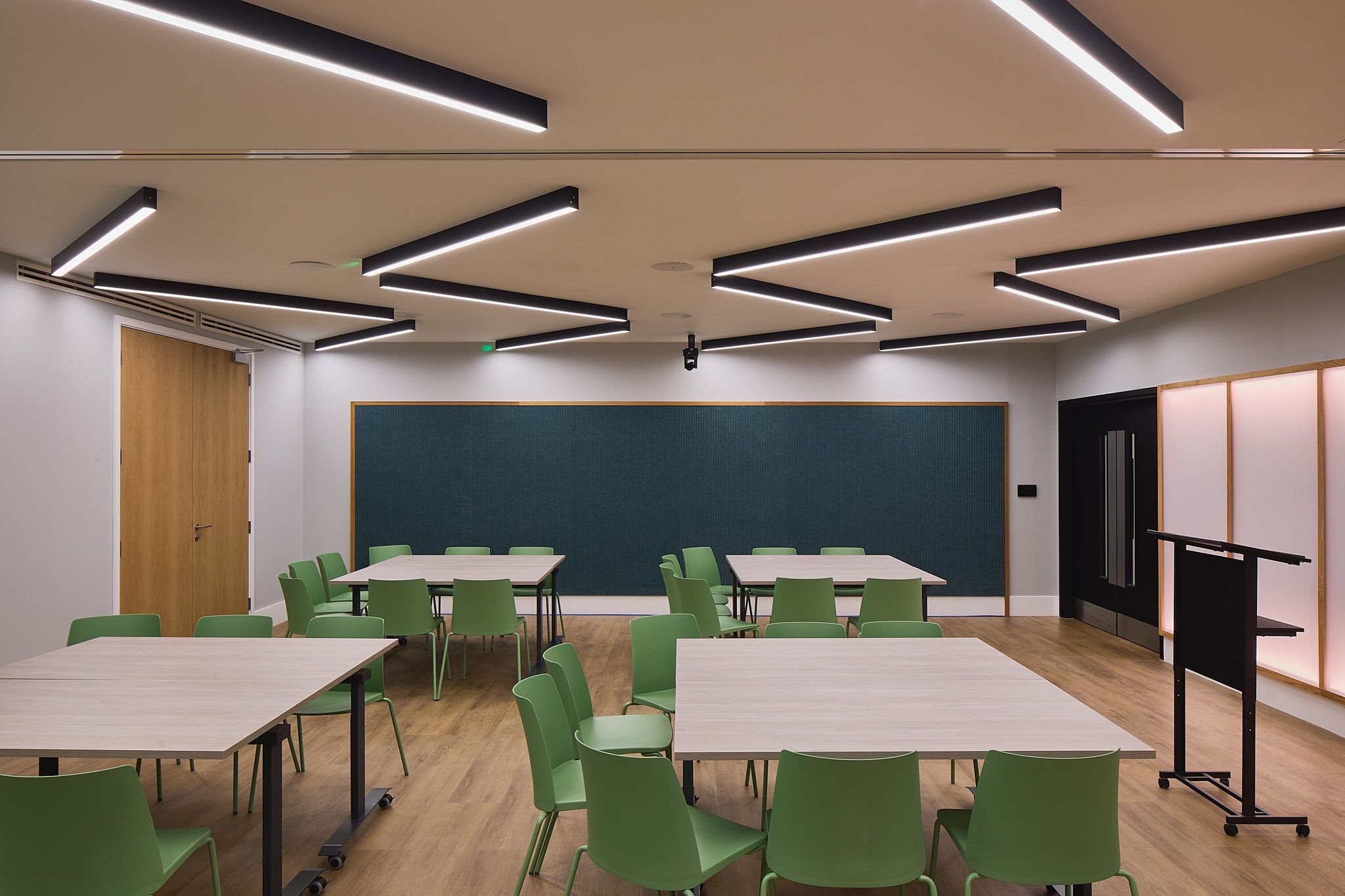 Modern auditorium with flexible seating for workshops and team gatherings at HubHub.