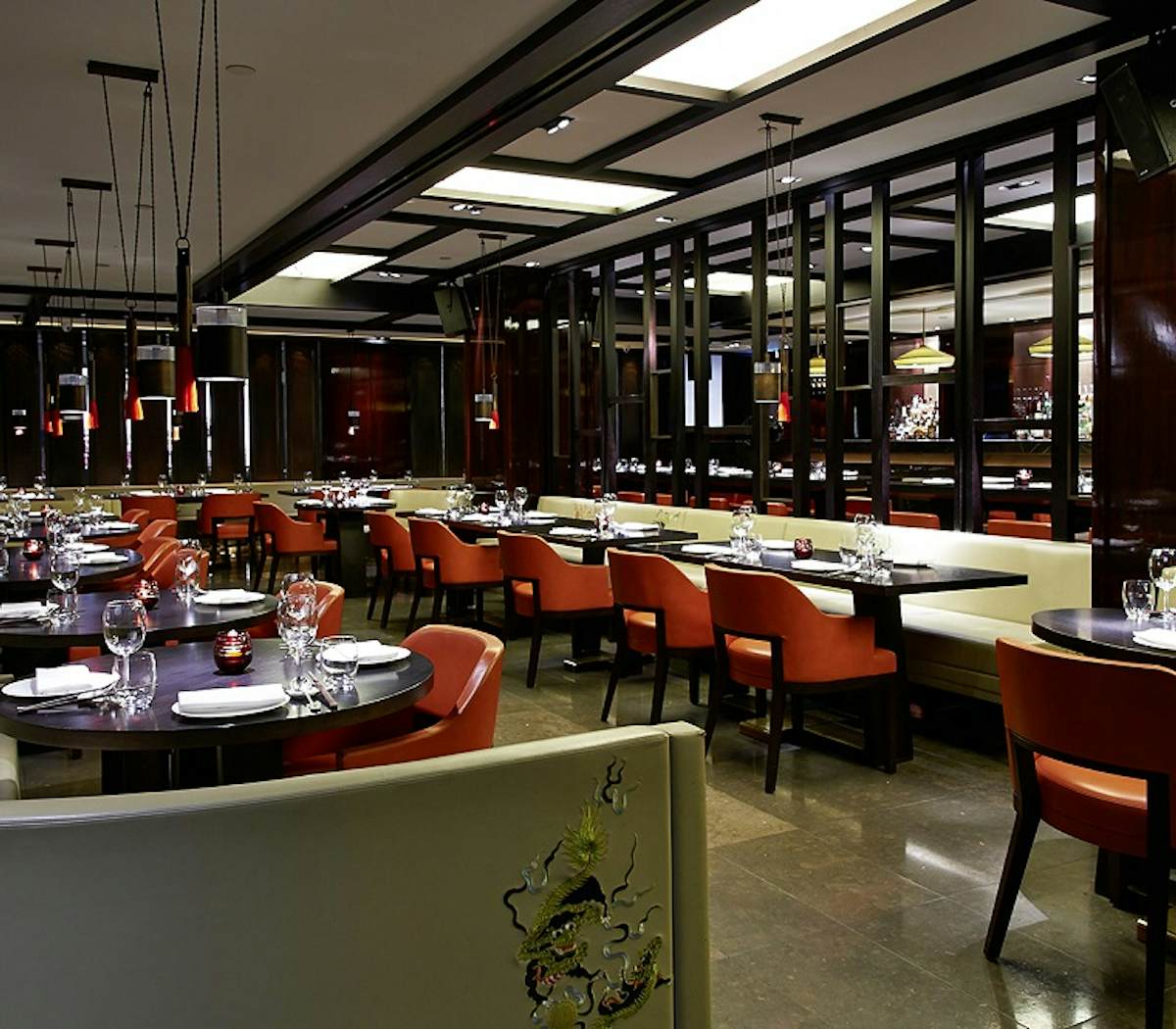 Contemporary dining area at Hakkasan with elegant table settings for corporate events.