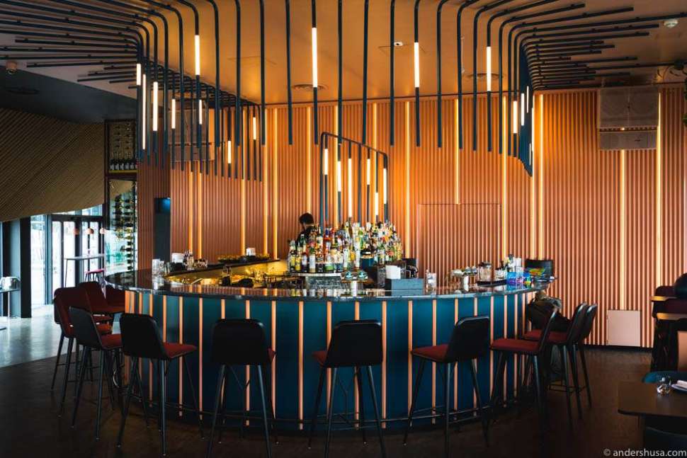 Contemporary bar at Hakkasan with vibrant lighting, perfect for networking events.