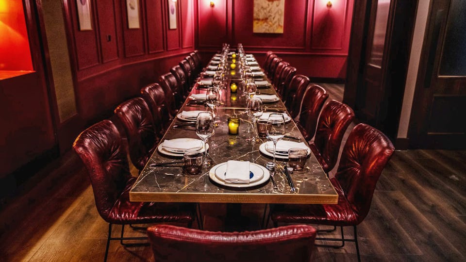 Elegant private dining room with marble table, ideal for corporate events or gatherings.