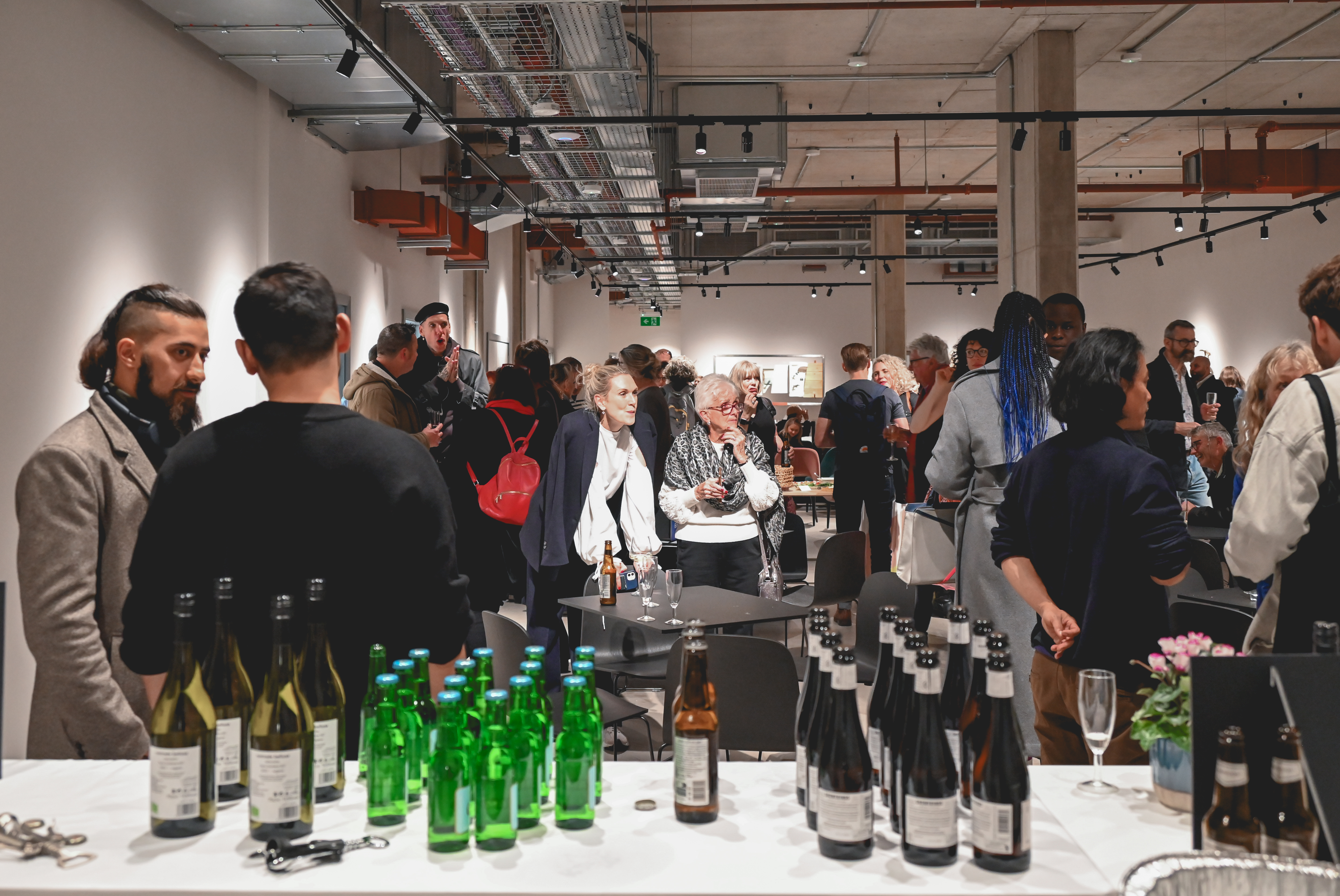 Vibrant networking event at The Hub with engaged attendees in a modern setting.