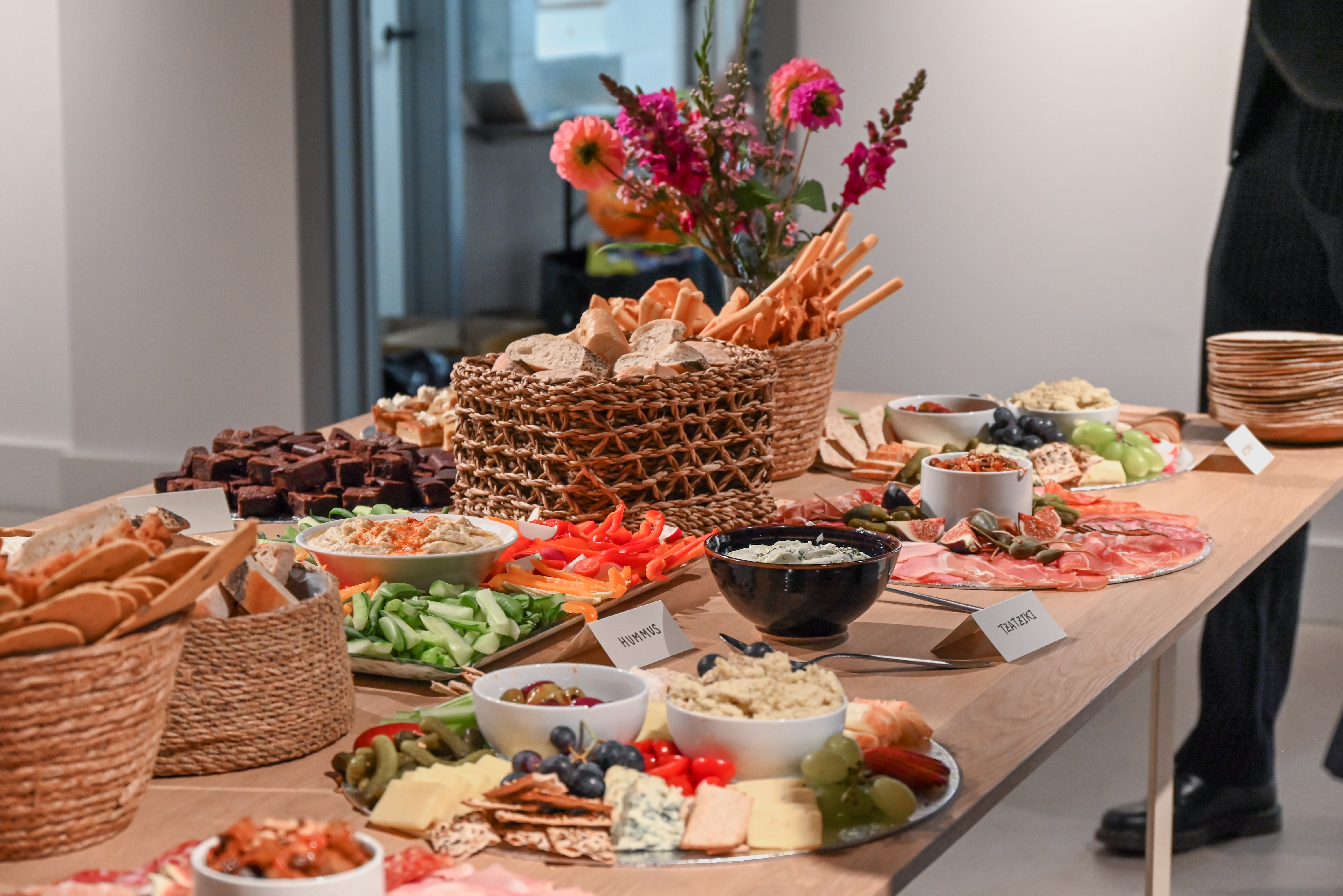 Elegant snack table with cheese and charcuterie for networking events at The Hub.