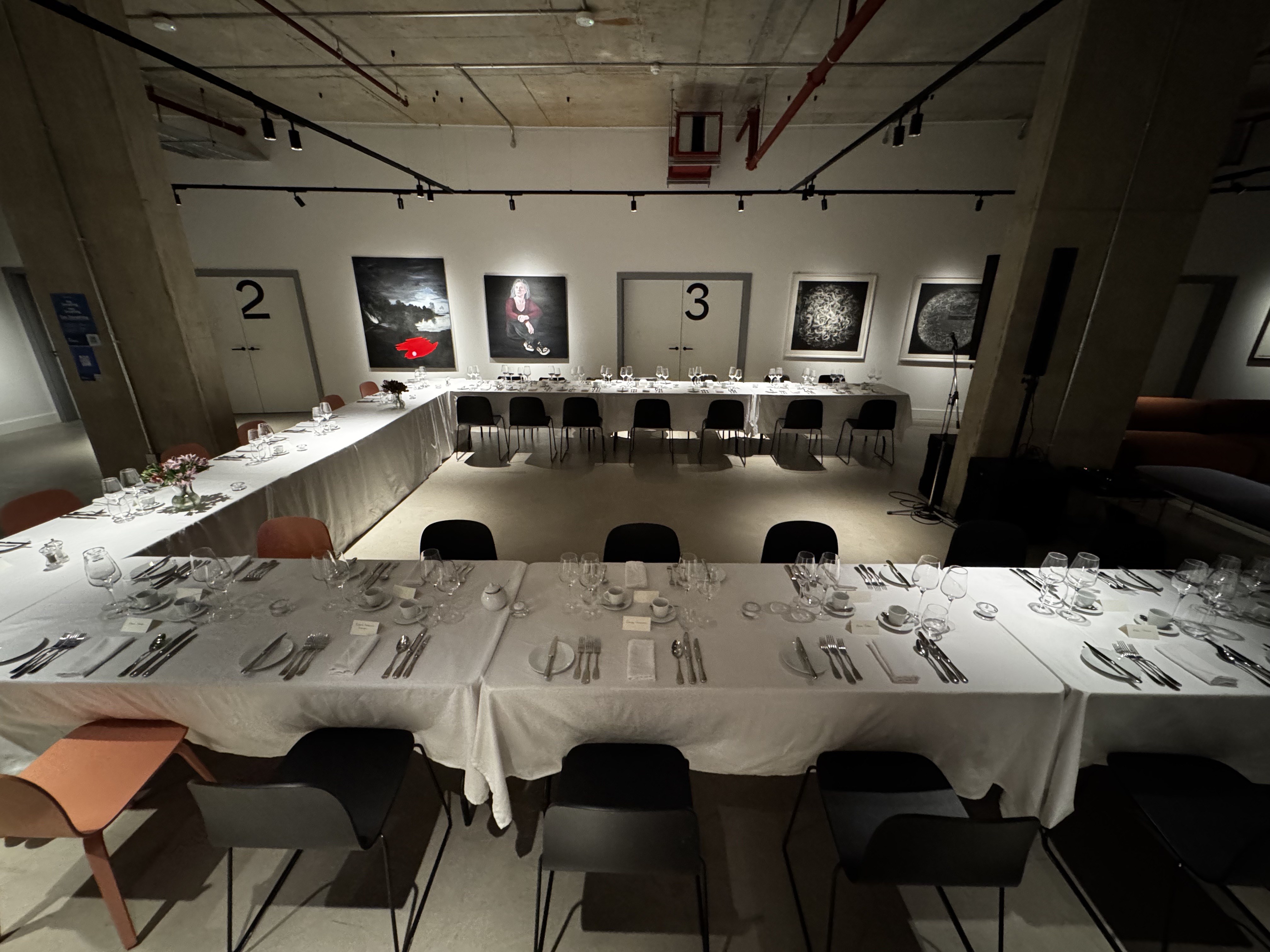 Sleek modern event space in The Art Academy set for intimate networking dinner.
