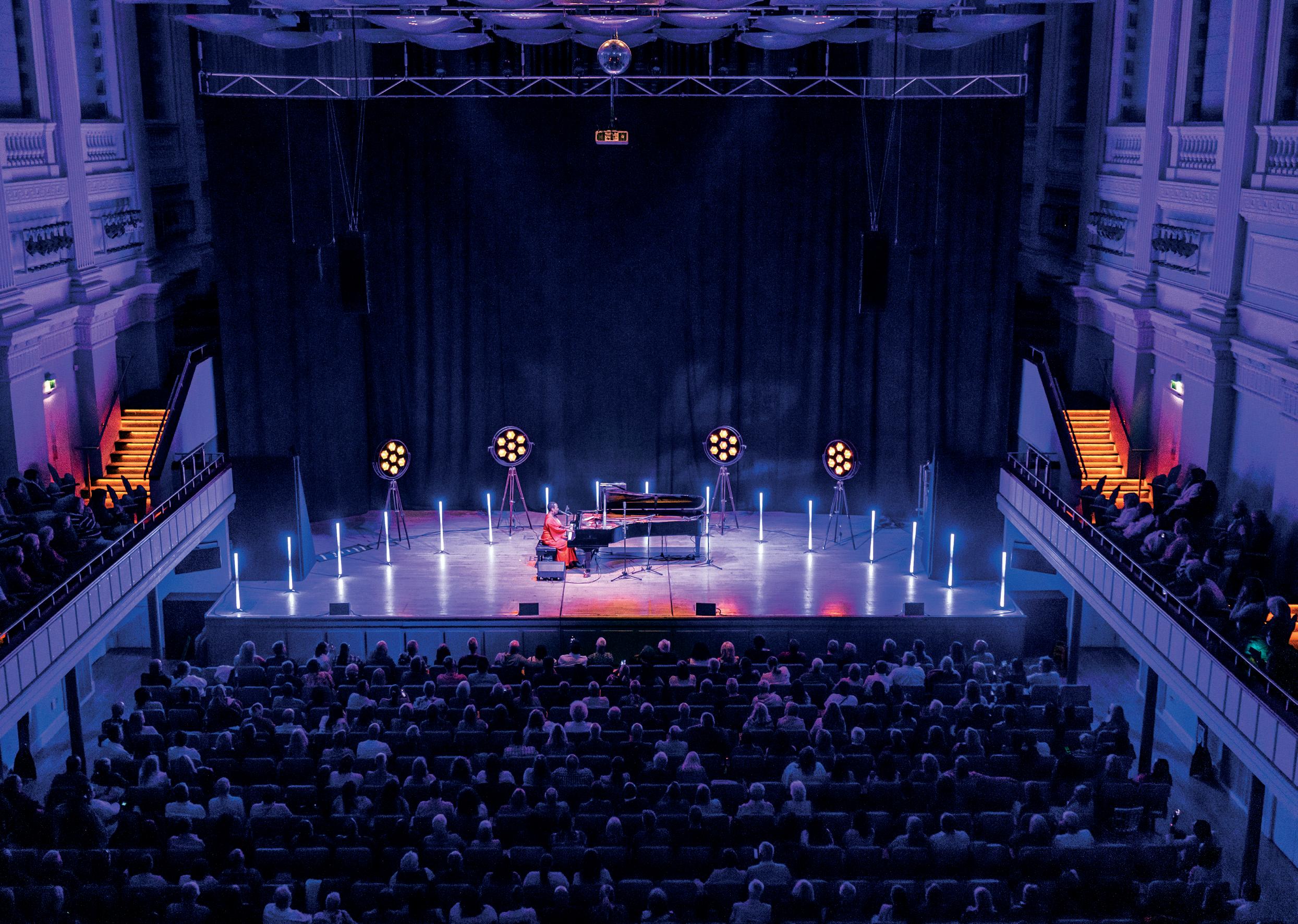 Justham Family Room stage with dramatic lighting for live concerts and events.
