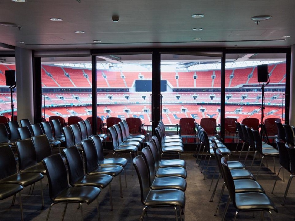 Pitch View Room at Wembley Stadium with sleek chairs for corporate meetings and presentations.
