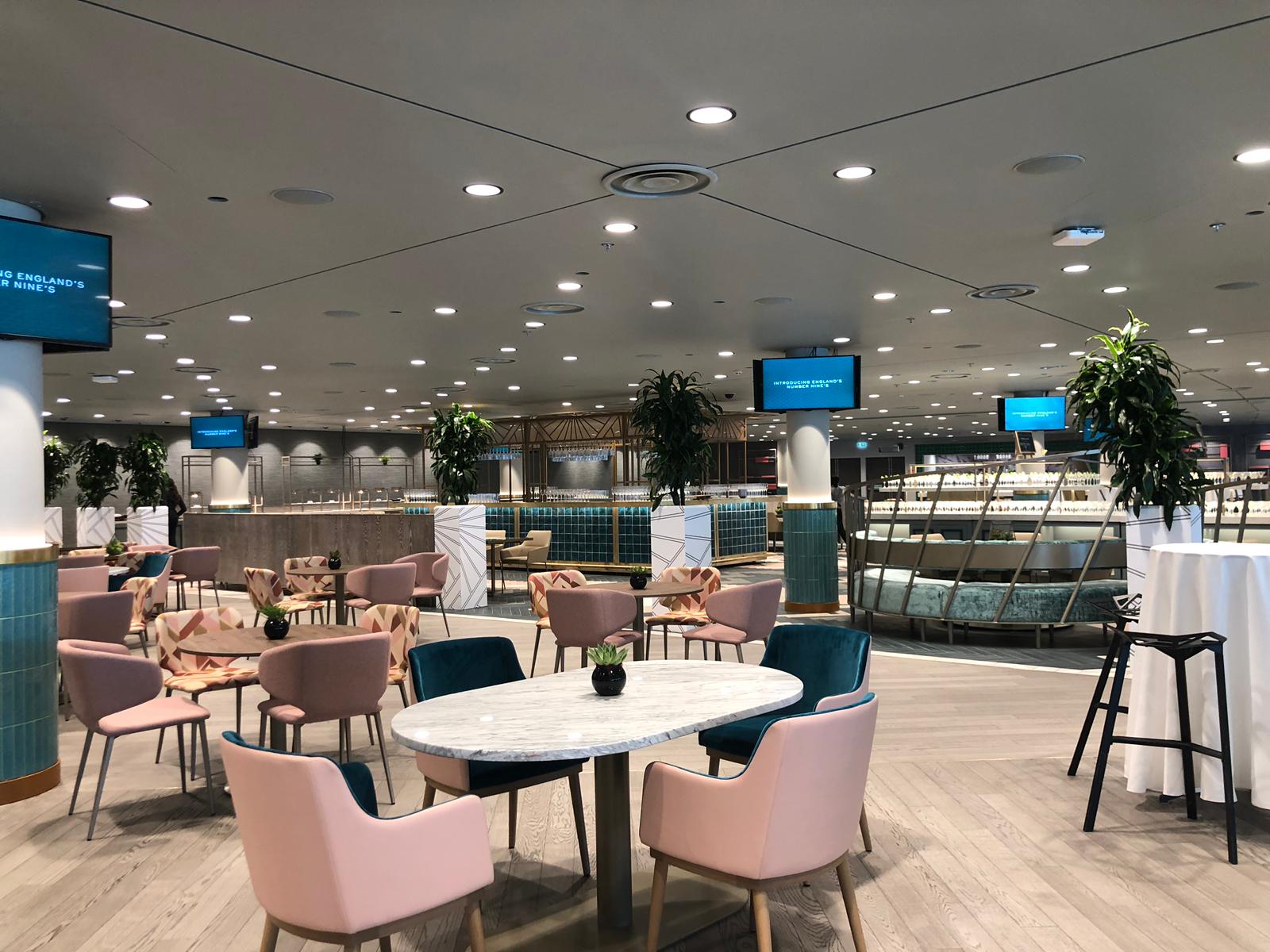 Modern event space in Wembley Stadium with stylish seating and natural light.