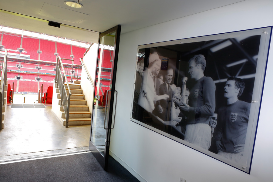 Wembley Suite corridor with historic athlete photo, ideal for corporate events and sports gatherings.