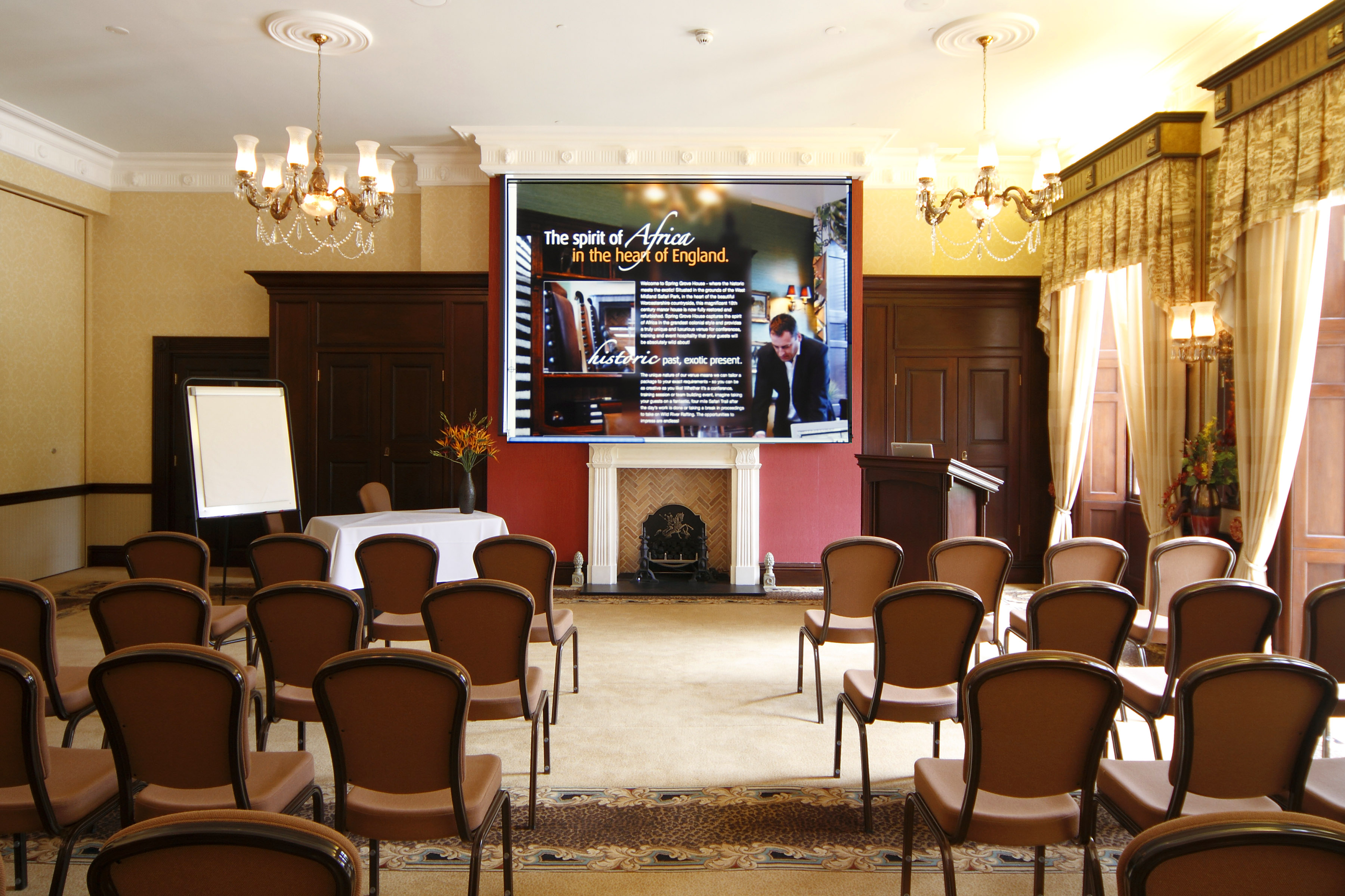 Spring Grove House meeting room with large screen, perfect for corporate events and seminars.