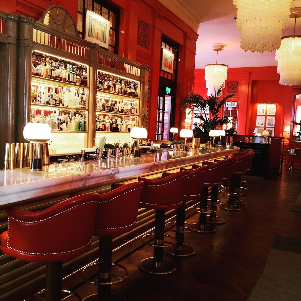 Vibrant Coral Room bar with elegant marble counter, perfect for networking events.