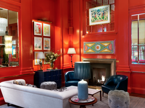 Vibrant Coral Room with bold red walls for creative meetings and discussions.