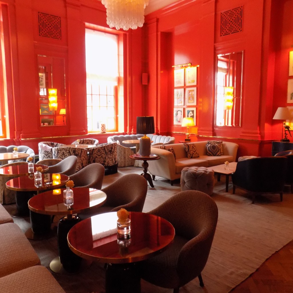 Vibrant lounge area with plush seating at Small Plates restaurant, ideal for networking events.